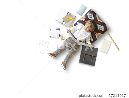 Little boy sits and plays on the floor among his toys Little boy sits and plays on the floor among his toys 57215017