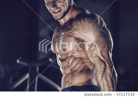 Brutal strong men workout bodybuilding background - muscular bodybuilder men doing exercises in gym 57217510