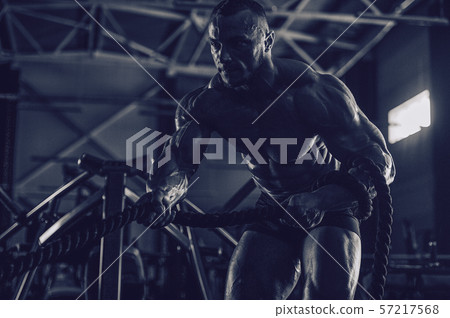 Brutal men muscles workout bodybuilding concept background muscular bodybuilder men exercises in gym Brutal men muscles workout bodybuilding concept background muscular bodybuilder men exercises in gym 57217568