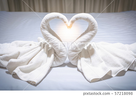 Towel is made of a white swan in the bed Towel is made of a white swan in the bed 57218098
