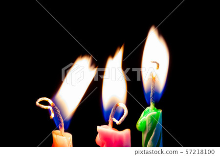 Three birthday candles on black background 57218100
