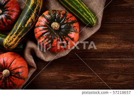 Flat lay Photo Orange pumpkins and green zucchini Flat lay Photo Orange pumpkins and green zucchini 57218657