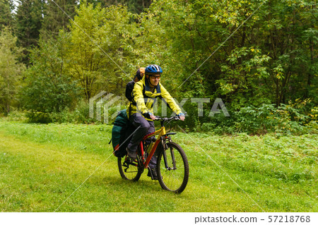 bicycle tourist in the autumn forest bicycle tourist in the autumn forest 57218768