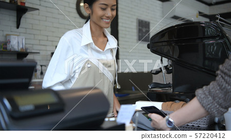 Coffee shop concept. The girl is suggesting that Coffee shop concept. The girl is suggesting that 57220412