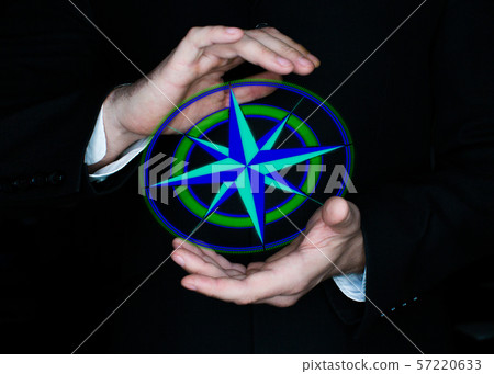 Male hands keeps digital compass wind rose. Travel and worldwide business concept. Male hands keeps digital compass wind rose. Travel and worldwide business concept. 57220633