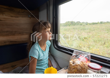 Girl sitting in a reserved seat wagon looks Girl sitting in a reserved seat wagon looks 57221273