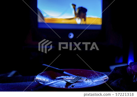 empty plate in front of tv - lonely night empty plate in front of tv - lonely night 57221318