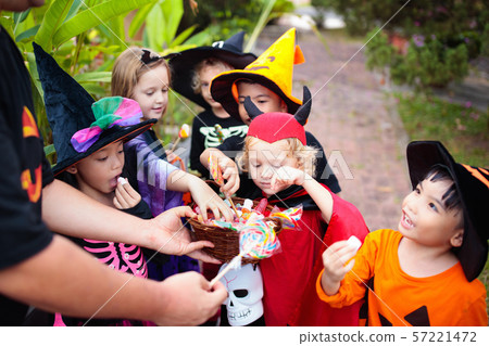 Kids trick or treat. Halloween. Child at door. 57221472