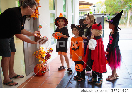 Kids trick or treat. Halloween. Child at door. 57221473