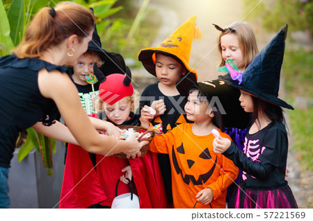 Kids trick or treat. Halloween. Child at door. 57221569