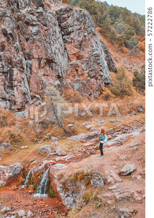 Female hiker walking in mountains forest. 57222786