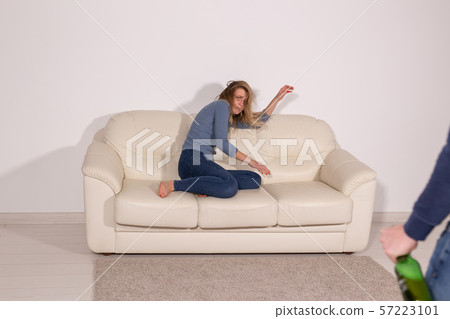 alcoholic, domestic violence and abuse concept - man gets drunk at home and takes his anger at his 57223101