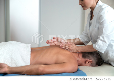 Female medic is doing back massage in hospital Female medic is doing back massage in hospital 57224770