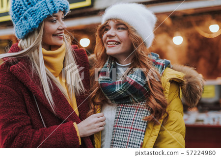 Happy best friends looking at each other during talk 57224980