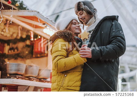 Happy loving couple walking near Christmas market Happy loving couple walking near Christmas market 57225168