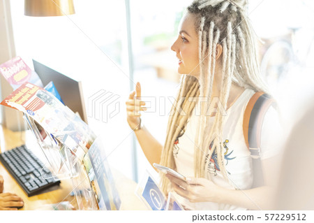Blonde Russian looking at a tourist information pamphlet for foreigners Blonde Russian looking at a tourist information pamphlet for foreigners 57229512