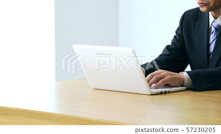 Mature man using a personal computer 57230205