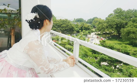 Side view of a woman wearing a hanbok Side view of a woman wearing a hanbok 57230559