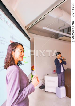 Business image: A scene that explains the system development schedule to the orderer in a good teamwork with colleagues 57231330