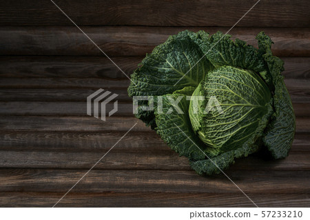 Savoy cabbage on a  rustic wooden background 57233210