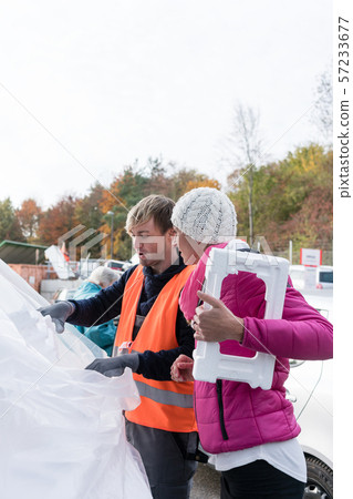 Woman and man on recycling center with Styrofoam Woman and man on recycling center with Styrofoam 57233677