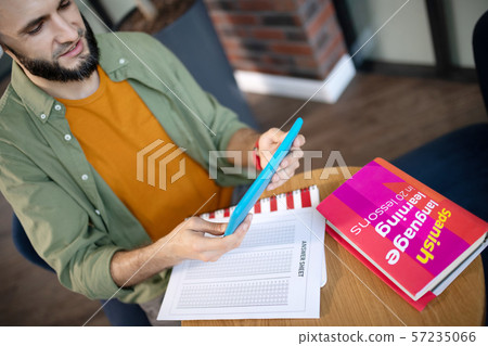 Student listening to recording while studying language 57235066