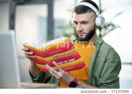 Close up of man having audio lesson in Portuguese language 57235094