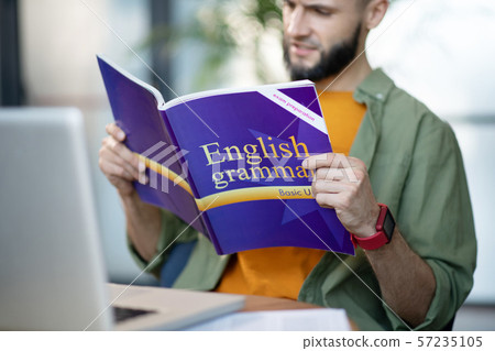 Man wearing smart watch repeating English grammar 57235105