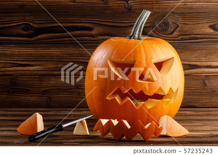 Carving Halloween pumpkin 57235243