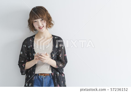 Woman using a smartphone Woman using a smartphone 57236152