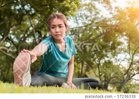 Young asian woman runner warm up and stretching 57236338