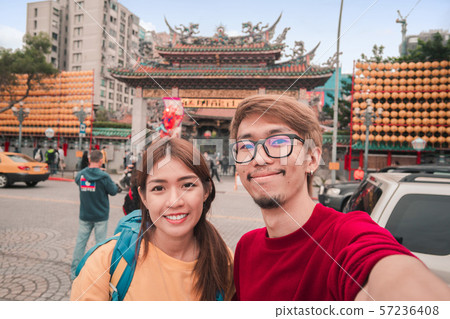Asian man and woman traveler with backpack Asian man and woman traveler with backpack 57236408