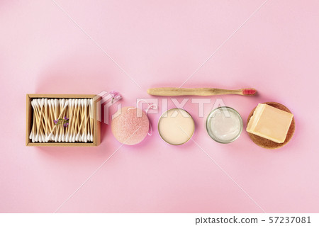 Plastic-free, zero waste cosmetics, flat lay on a pink background. Bamboo toothbrush, cotton swabs Plastic-free, zero waste cosmetics, flat lay on a pink background. Bamboo toothbrush, cotton swabs 57237081