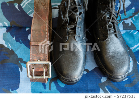 Army boots and army belt on blue camouflage Army boots and army belt on blue camouflage 57237535