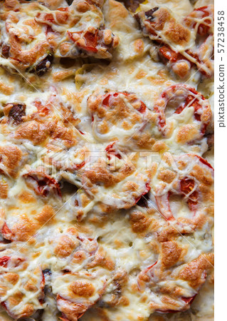 Baked vegetables with cheese sauce on a baking Baked vegetables with cheese sauce on a baking 57238458