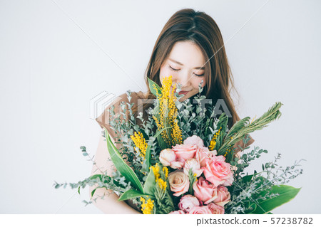 Young woman with a bouquet Young woman with a bouquet 57238782