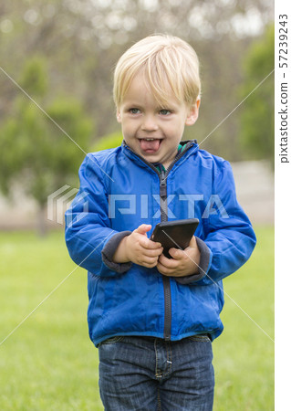 Child using a mobile phone 57239243