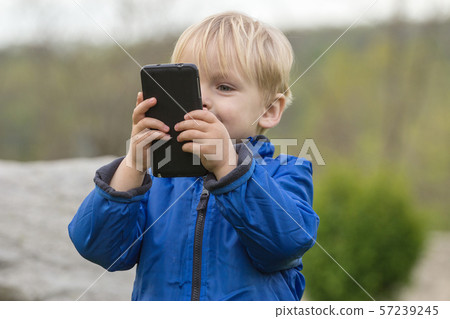 Child using a mobile phone 57239245