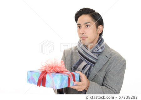 A smiling man with a present 57239282