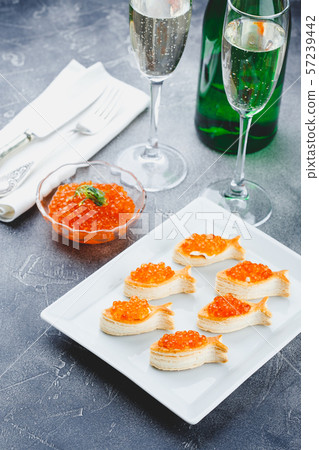 Delicious appetizer with red caviar. 57239442