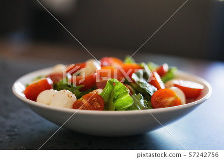 Salad with mozzarella balls tomatoes and mix salad Salad with mozzarella balls tomatoes and mix salad 57242756