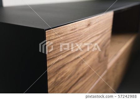 Closeup details of modern tv stand made from walnut and powder coated steed Closeup details of modern tv stand made from walnut and powder coated steed 57242988