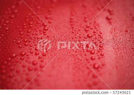 Closeup red car paint surface with hydrophobic ceramic coating 57243021