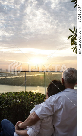 Asian senior couple with morning sunrise on luxury 57243534