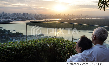 Asian senior couple with morning sunrise on luxury 57243535