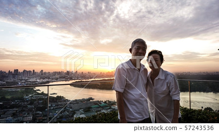 Asian senior couple with morning sunrise on luxury 57243536
