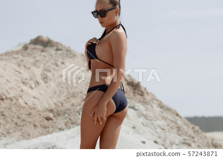Beautiful woman in swimsuit on beach Beautiful woman in swimsuit on beach 57243871
