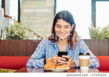 Texting pretty young woman 57245620