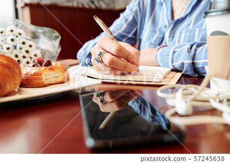 Woman writing plans in diary 57245638