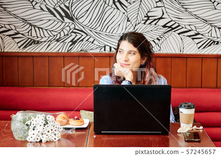 Smiling woman in cafe 57245657